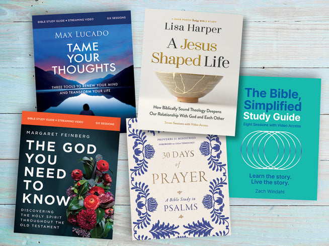 Various books related to the bible sitting on a table