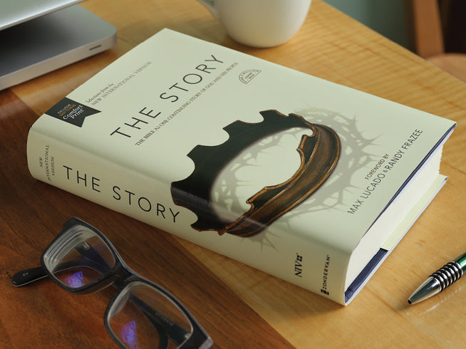 Image of the book The Story on a desk with glasses and a pen