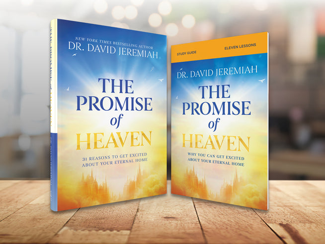Two copies of 'The Promise of Heaven' by Dr. David Jeremiah on a wooden surface with a blurred background.