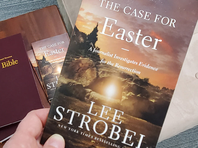 Book titled 'The Case for Easter' by Lee Strobei held by a person with other books in the background.