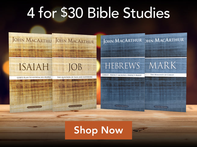 Promotional graphic for a Bible studies bundle showing four John MacArthur books: Isaiah, Job, Hebrews, and Mark. The books are arranged on a wooden surface against a dark blurred background, with the text '4 for $30 Bible Studies' at the top and an orange 'Shop Now' button at the bottom.