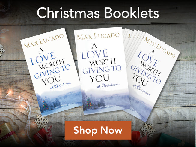 Three copies of the Christmas book 'A Love Worth Giving to You at Christmas' by Max Lucado are displayed on a rustic wooden background with holiday decorations, under the heading 'Christmas Booklets' and with a 'Shop Now' button.