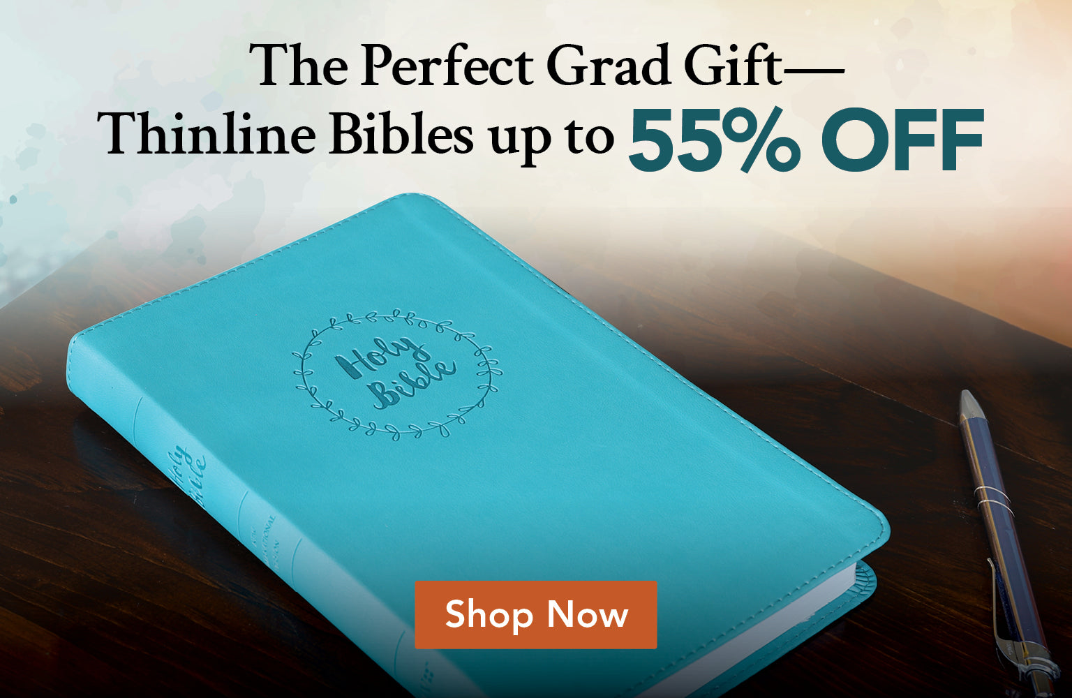 Teal Bible on a wooden surface with promotional text overlay. The Perfect Grad Gift - Thinline Bibles up to 55% off - Shop Now