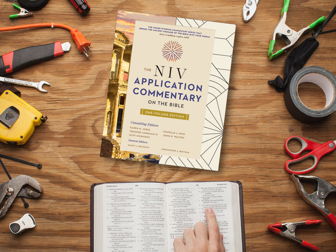 NIV Application Commentary on the Bible with tools on a wooden surface
