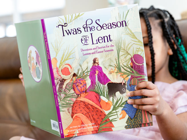 Person holding a book titled 'Twas the Season of Lent' with colorful illustrations on the cover.