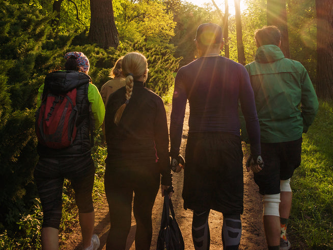 Group of people hiking at sunset