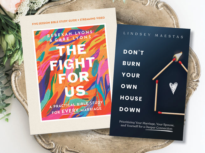 Two books on a decorative tray with a white background