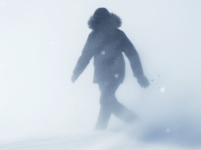 Person in warm clothing walking in snow