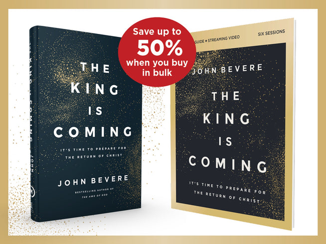 Two copies of the book 'The King Is Coming' by John Bevere are shown on a white background with a gold border. One copy is a dark navy blue hardcover with gold speckles, and the other is a gold-bordered paperback edition.